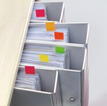 Folders with colored tabs on shelf