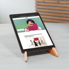 Tablet on wooden stand, website open