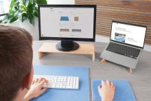 Person working on PC and laptop