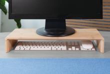 Monitor on wooden stand, including keyboard and mouse