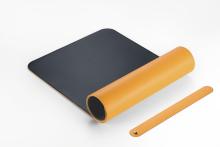 Orange-schwarze, entrollte Matte, daneben ein oranger Streifen