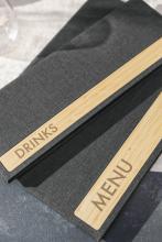 Grey menu cards with wooden strips, labelled DRINKS and MENU