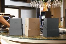 Three menu holders with menus on counter Glasses hanging in the background