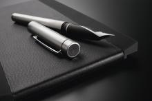 Fountain pen on black notebook