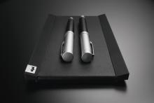 Two silver pens on a black, leather-like backing
