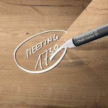 Wooden table with 'Meeting 1730' in white