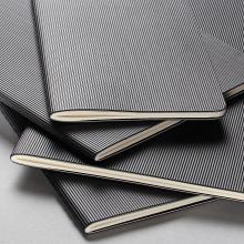 Several black-and-white striped notebooks, some overlapping