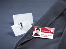 Name tag and suit lie next to each other