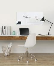 Modern desk with lamp, laptop and whiteboard